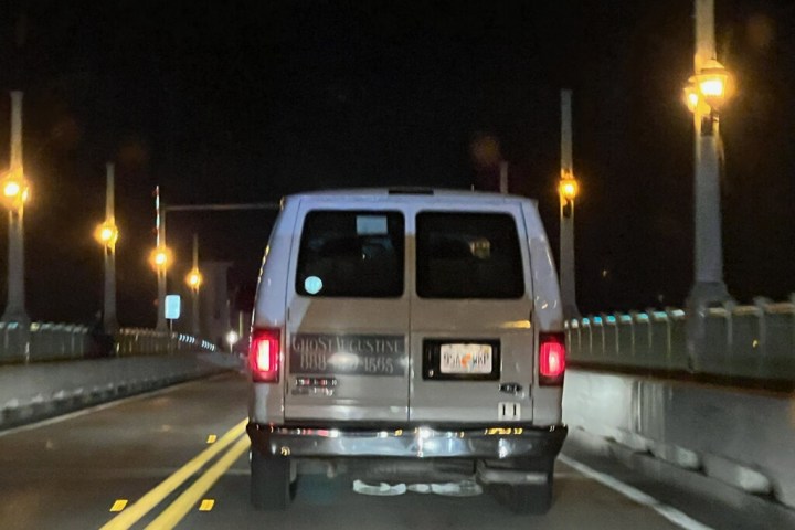 a car driving on a rainy night