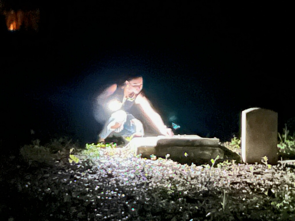 a man that is standing in the dark