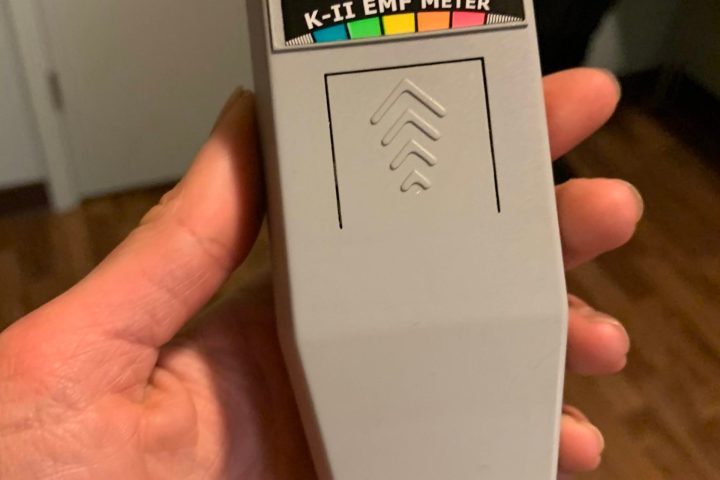 a hand holding a remote control