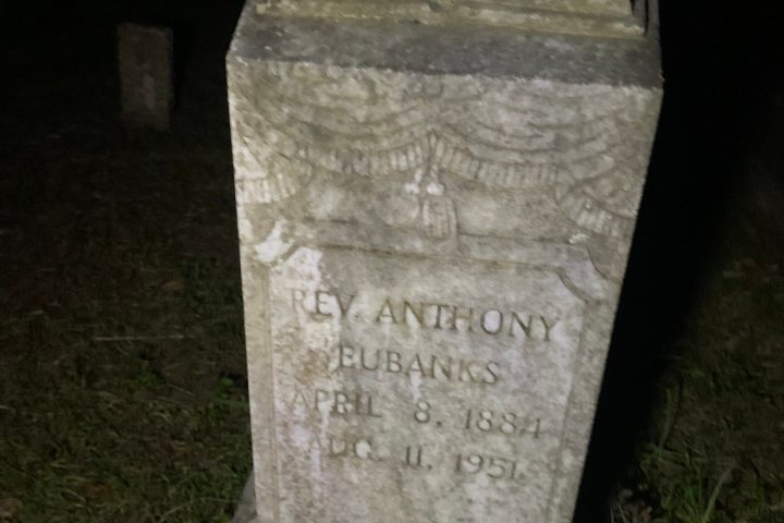 a gravestone in front of a stone building