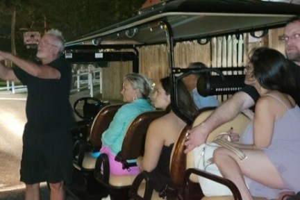 a man and a woman standing next to a car