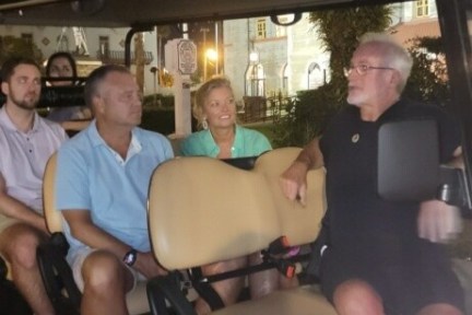 a group of people sitting around a car