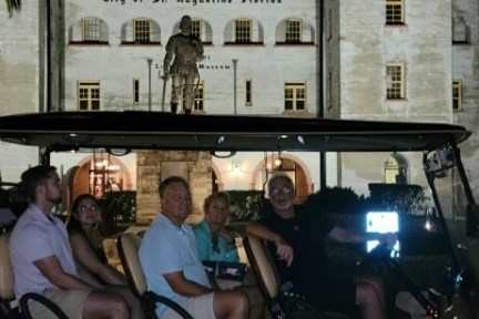 a group of people sitting in front of a building