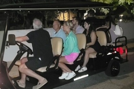 a group of people sitting on a motorcycle