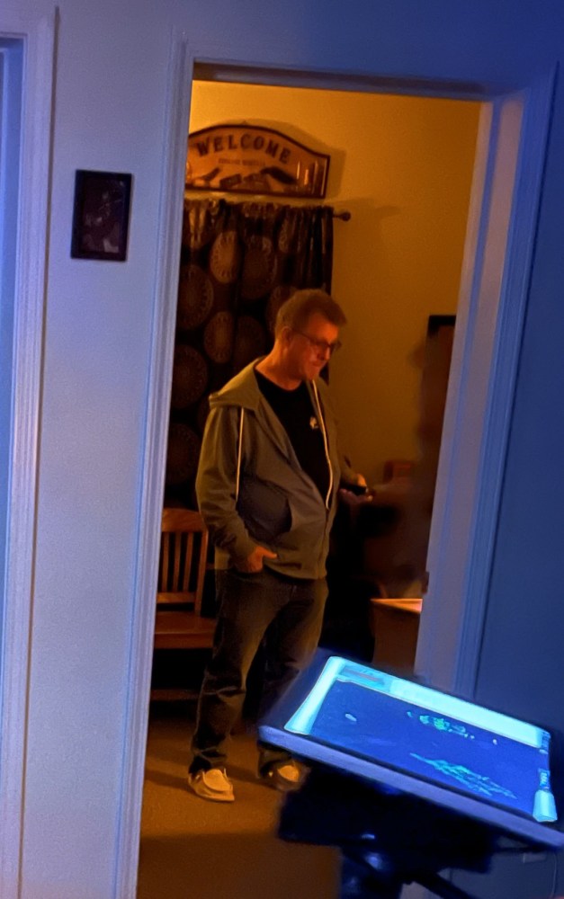 a man standing in front of a computer screen