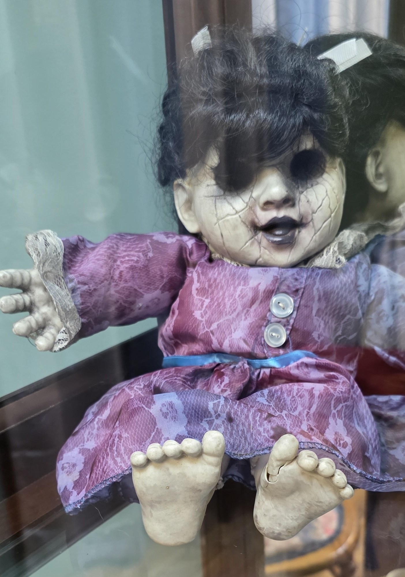 SallyCrop a doll sitting on top of a stuffed toy